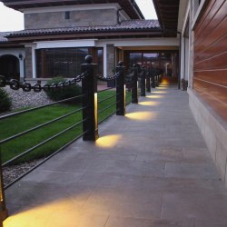 A modern wrought iron railing with a chain