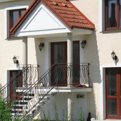 A wrought iron railing - house entrance